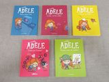four children ' s books are lined up on a table