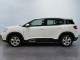 the white suv is parked in a room with a gray floor