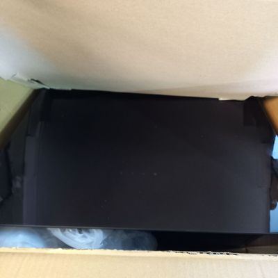 a box with a laptop inside of it on the floor