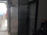 a refrigerator that is in the middle of a kitchen