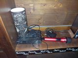 a microphone and a speaker on a shelf in a room