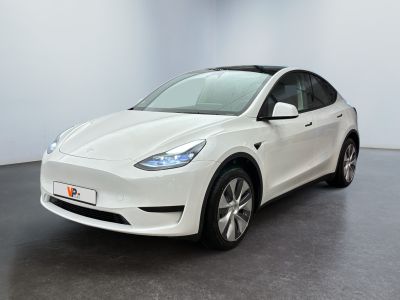 a white tesla model x parked in a white room