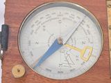 a wooden clock with a blue handle on a white background