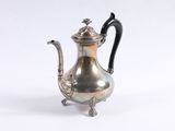 an antique silver tea pot with a black handle on a white background