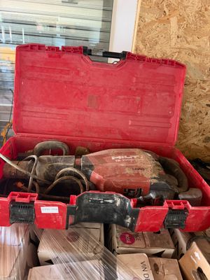 a red tool box with tools in it on a table