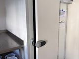 a white refrigerator in the corner of a kitchen