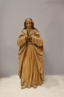a statue of a man holding a rosary in his hands