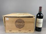 an open wooden box with a bottle of wine next to it