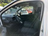 the interior of a car with the door open and the driver ' s seat down