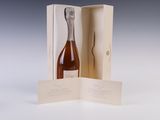 a bottle of wine in a box on a table