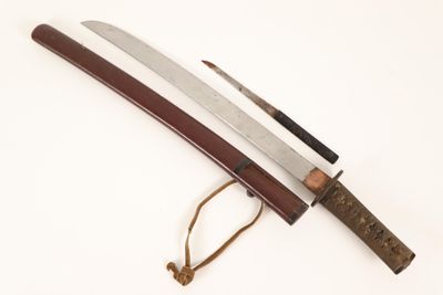 a close up of a knife with a wooden handle on a white surface