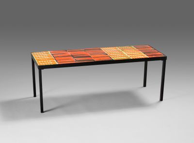 a table with a colorful tile top and metal legs