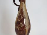 a brown and white vase sitting on a table