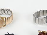 several different types of watches are displayed on a white surface