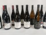 several bottles of wine are lined up on a white surface