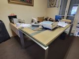 a desk with a laptop and a bag on it