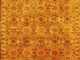 an orange and yellow rug with a floral design on it