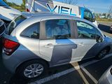 a silver car parked in a parking lot next to other cars