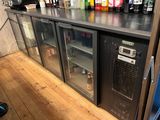 many bottles of alcohol sitting on top of a bar