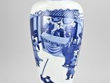 a blue and white vase with a picture of people on it