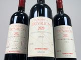 three bottles of red wine sitting on top of a white table