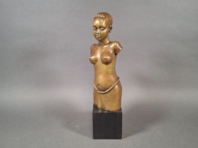 statue of a woman with a large breast on a wooden base