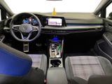 the interior of a car with blue seats and a steering wheel