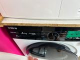 a person that is putting something in a washing machine