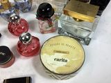 a lot of different perfumes on a white table