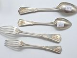 five spoons and a fork sitting on a table