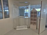 a bathroom with a toilet and a shelf in it