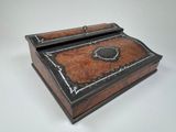 an old wooden box with a black and brown design on it