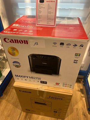 une imprimante Canon posée sur un carton