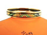 an image of a gold ring with a flower design on it