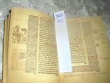 an open book with a piece of paper on top of it