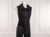 the woman is wearing a black jacket and pants on a mannequin