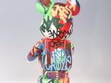 a multicolored teddy bear with graffiti on it