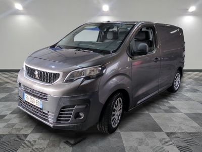 the silver van is parked on a checkered floor in a room