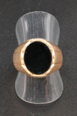 a ring with a black stone in it sitting on a table