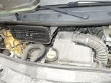 the engine of a car with its hood open and the hood down