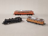 trois petits trains posés sur une surface blanche
