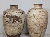 two vases sitting next to each other on a table