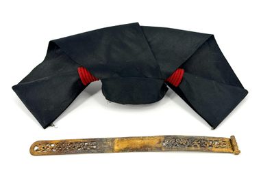 a black hat and a knife on a white surface