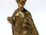 an antique bronze statue of a woman holding a cane