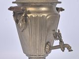 a silver urn with a handle on a white background