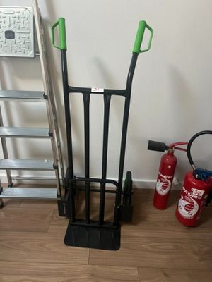 a fire extinguisor and a ladder next to a fire hydrant