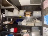 a kitchen with a lot of dishes on the shelves