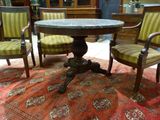 two chairs and a table on a rug in a room