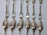 a lot of silver spoons and forks on the table