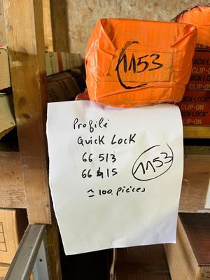 a sign on the back of a chair that has a bag on top of it